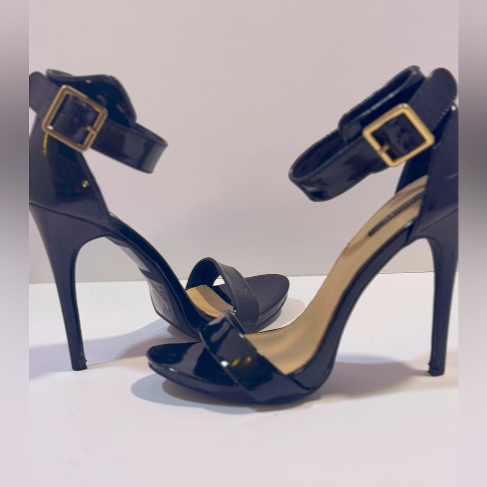 Black strappy stilletos in faux patent leather